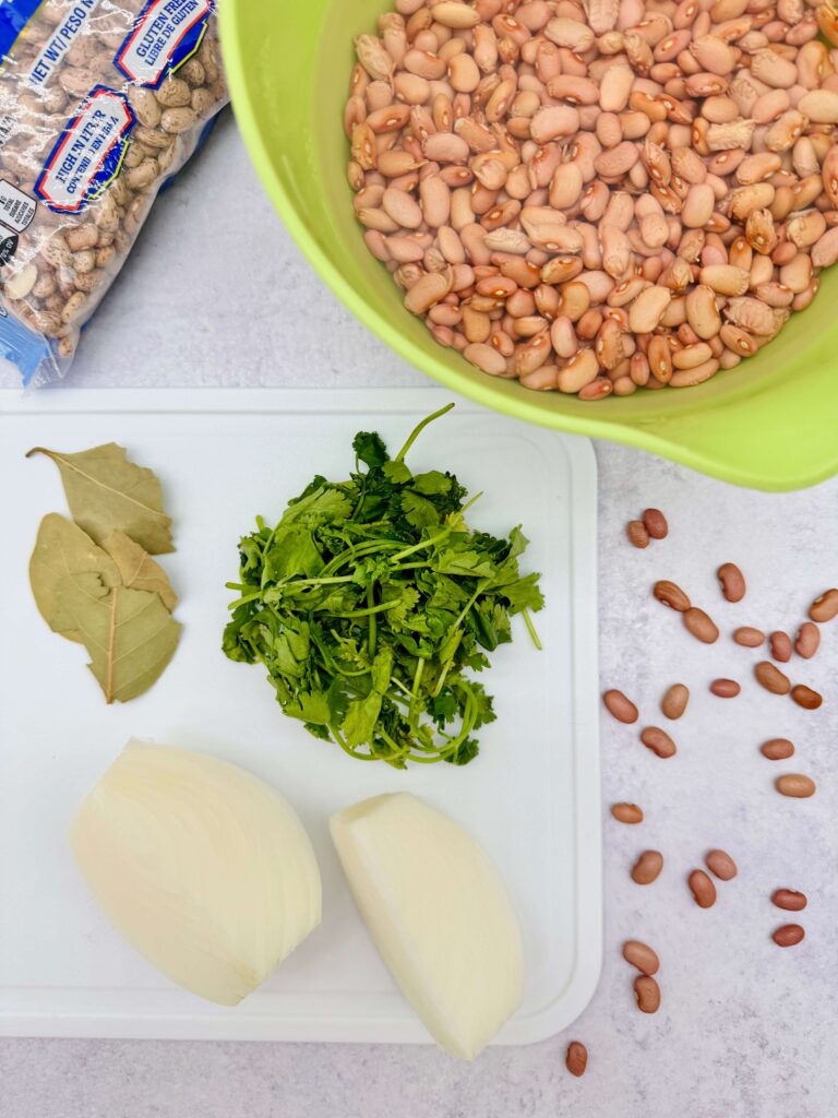 Pinto beans, onion, cilantro, and bay leaves prepared for plant based arroz con pollo, perfect for meatless dinner ideas.