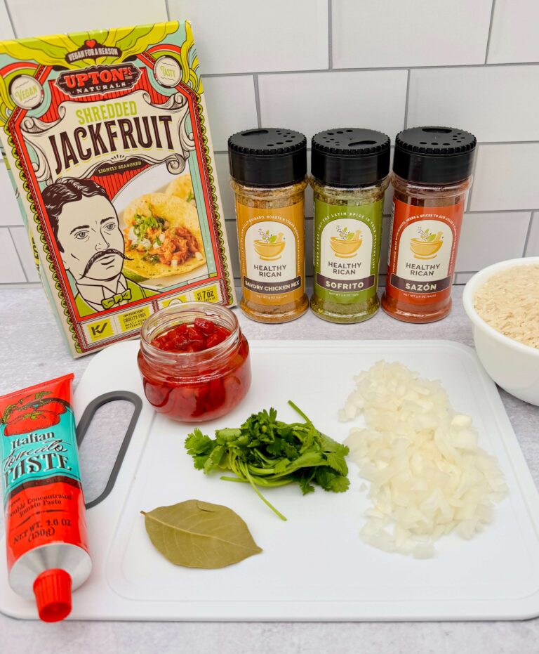 Shredded jackfruit, rice, tomato paste, and seasonings used to make plant based arroz con pollo for simple vegan recipes.
